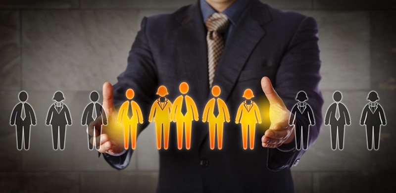Blue chip recruitment manager selecting a group of five employees in a lineup of worker icons. Business concept for team building, customer segmentation and management succession. Wide composition.