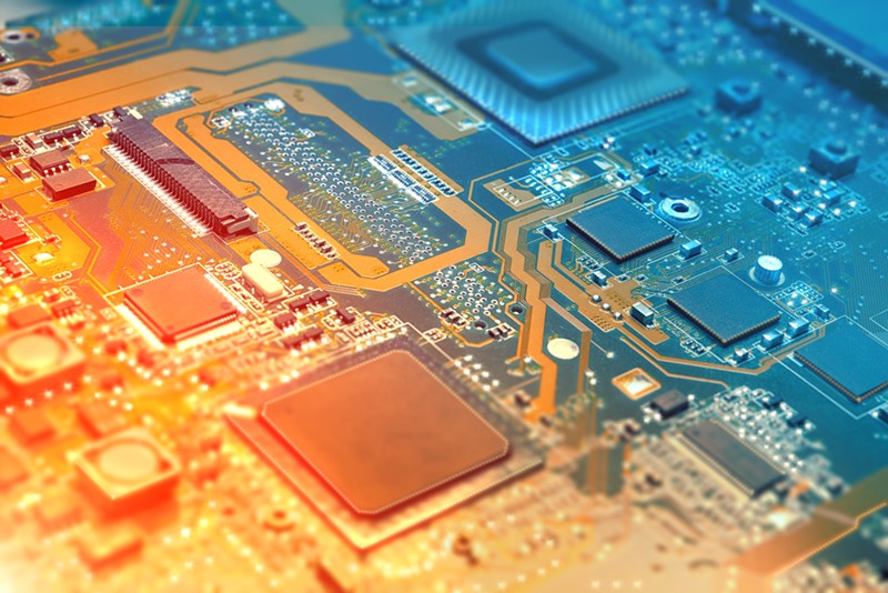 Closeup on electronic board in hardware repair shop, blurred and toned image. Shallow DOF, focus on the middle left field
